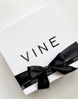 luxury gift packaging beautifully gift wrapped in white and black contrasting ribbon