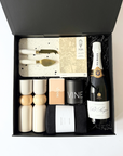 beautiful house warming gift box with pol roger champagne and all the beautiful things a house owner can enjoy. Salt and Pepper grinders, soy candle, cheeseboard board and hand towel