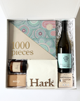 a unisex get well or wellness gift for any occasion. Contains a 1000 piece puzzle wine, kitsch solid shampoo, coffee beans from hark, hand poured soy candle and commonfolk soap