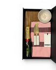 Ladies house warming gift containing Moet champagne, Hommey tea towel, ceramic unique hand made dish and cheeseboard and knives.  