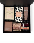Luxury pamper gift box for women featuring Prohibition Negroni gin, Kitsch pink silk pillowcase, Kitsch hair scrunchies, Alive hand cream, Koko Black pink salted vanilla chocolate and an Ecosoy soy hand-poured candle