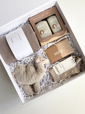unisex newborn baby gift with fluffy camel rattle, soap, Alive traveller pack, ecovask hand towel and quality merino wool baby socks